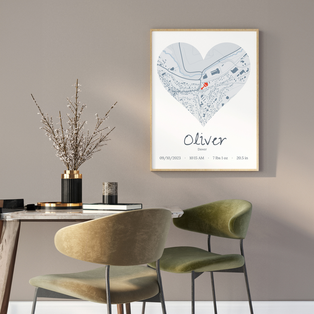 Personalized baby birth stats print with a heart-shaped city map in a natural wood frame on a dining room wall