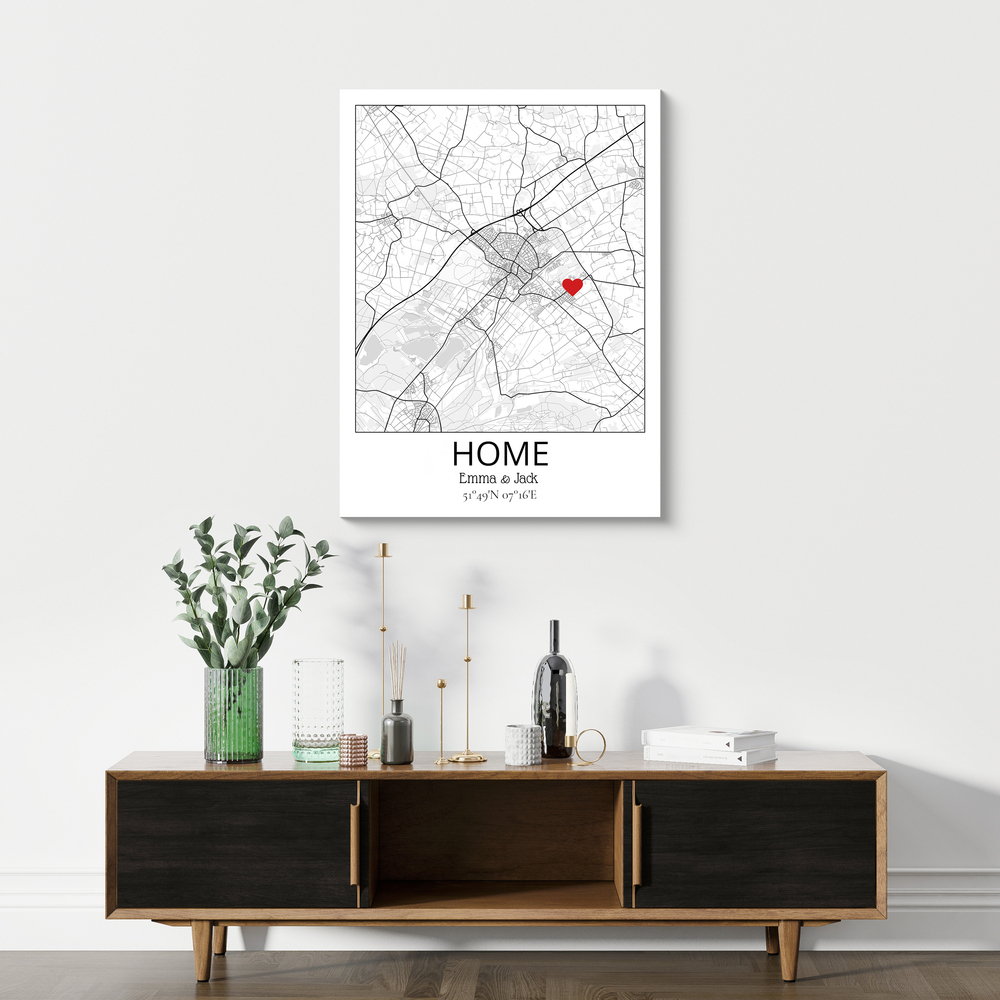 Personalized black-and-white home map print with a red heart marker, displayed above a wooden sideboard