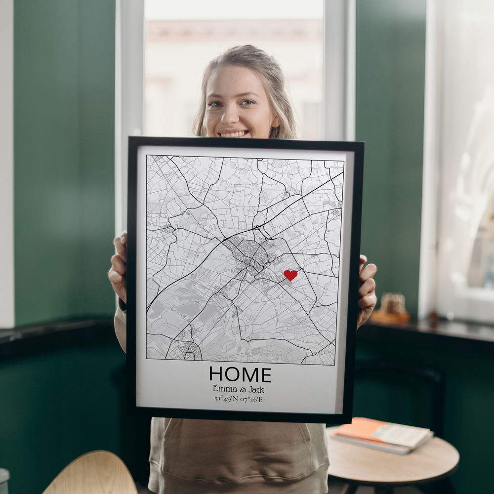 Custom home map poster in a black frame with a red heart marking the address, a personal housewarming gift
