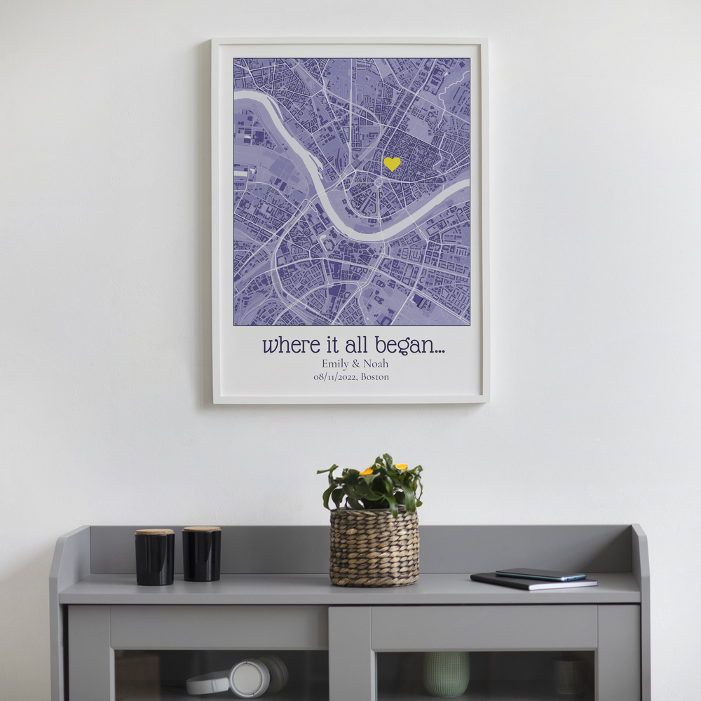 Custom city map with a yellow heart in a white frame above a gray cabinet, a thoughtful anniversary gift