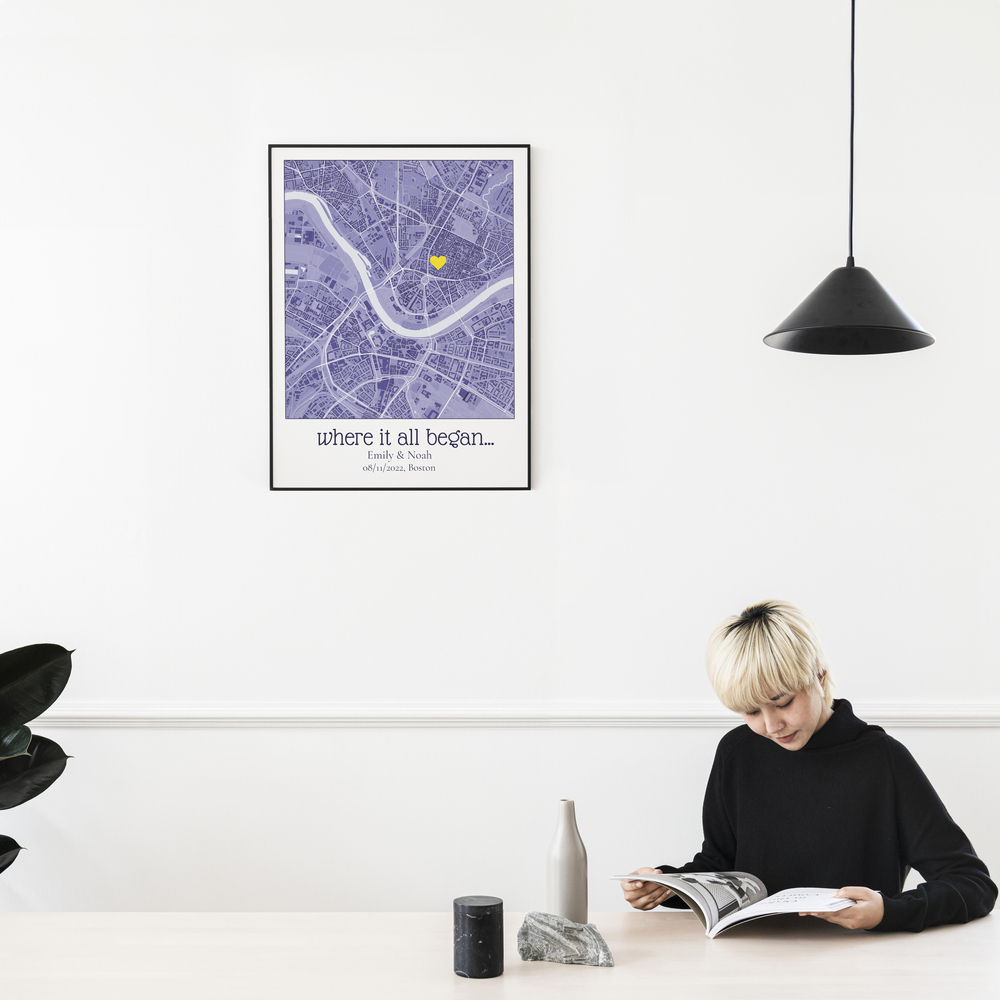 Personalized purple city map with a yellow heart in a black frame above a table, an anniversary gift for couples.
