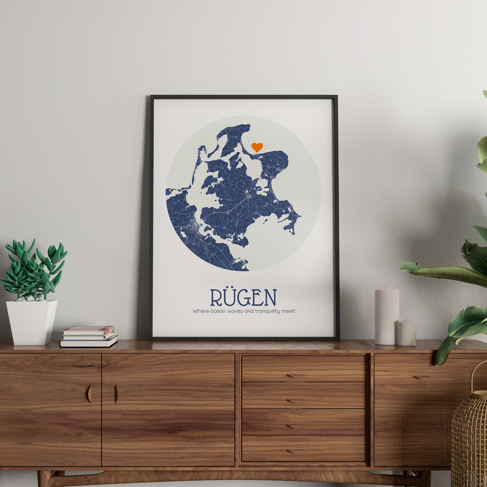Circular blue Rügen map in a black frame on a wooden sideboard, a vacation keepsake gift for couples