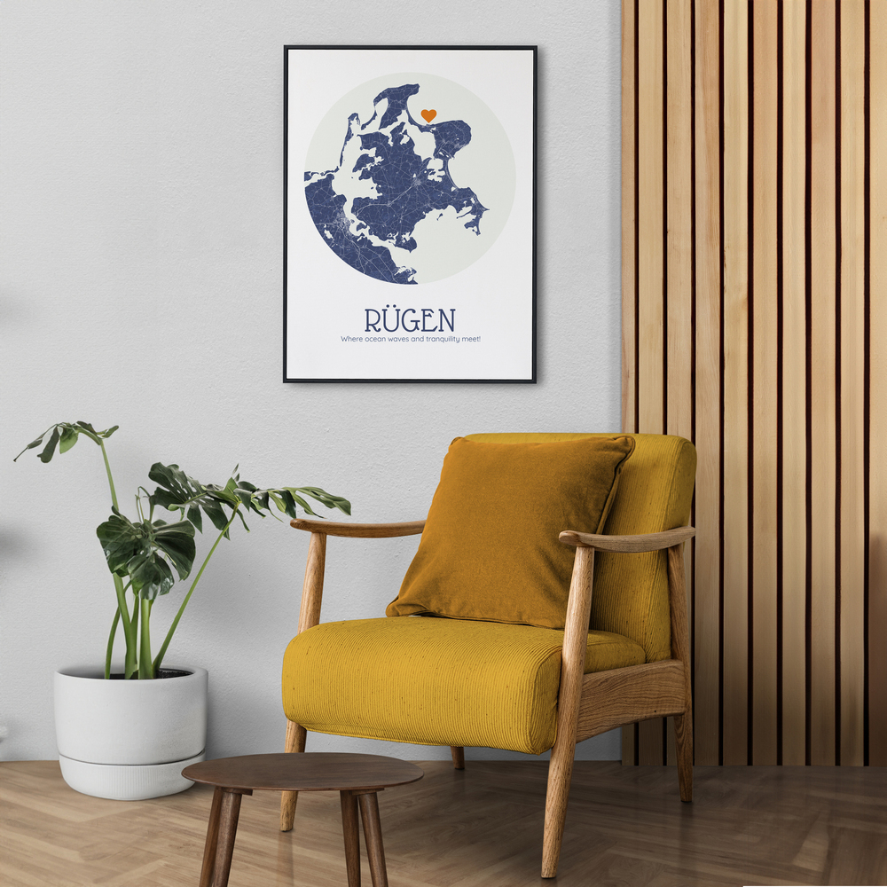 Framed Rügen map poster with a circular blue design and orange heart, on the wall above a mustard-yellow chair